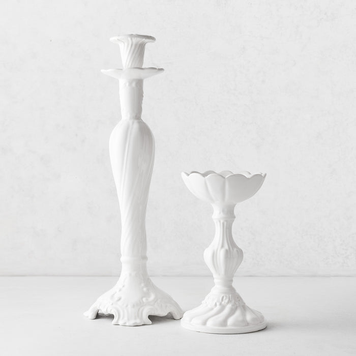 Small and large Tosca white ceramic candlesticks with ornate Italian-inspired designs and glossy glaze finish.