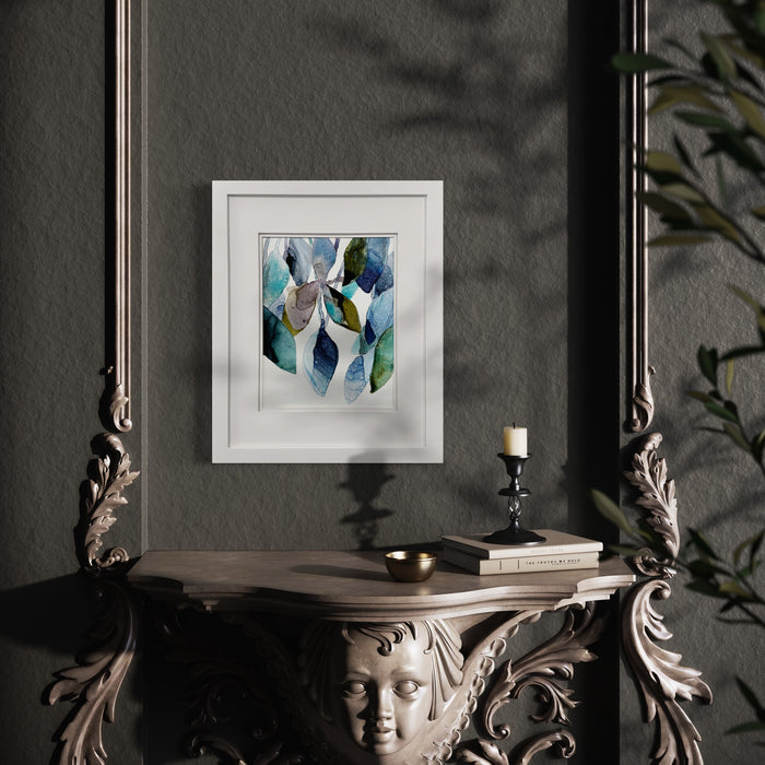 The artwork 'Something Blue I' by Rachel Kohn features flowing abstract shapes in watercolor and ink on yupo paper, showcasing fluid curves in shades of turquoise, deep blue, and sage green. The organic forms create a dynamic composition with translucent layers and graceful movement. White framed artwork against dark wall.