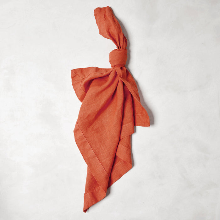 Spice HG Hand-Dyed Linen Napkin, 22", tied in a knot, on a white background.